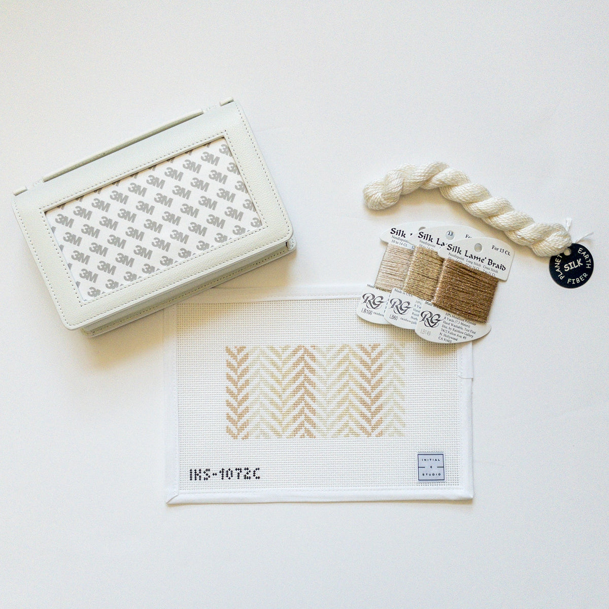 Mini Herringbone clutch in neutral, finished example of the Initial K Studio needlepoint canvas
